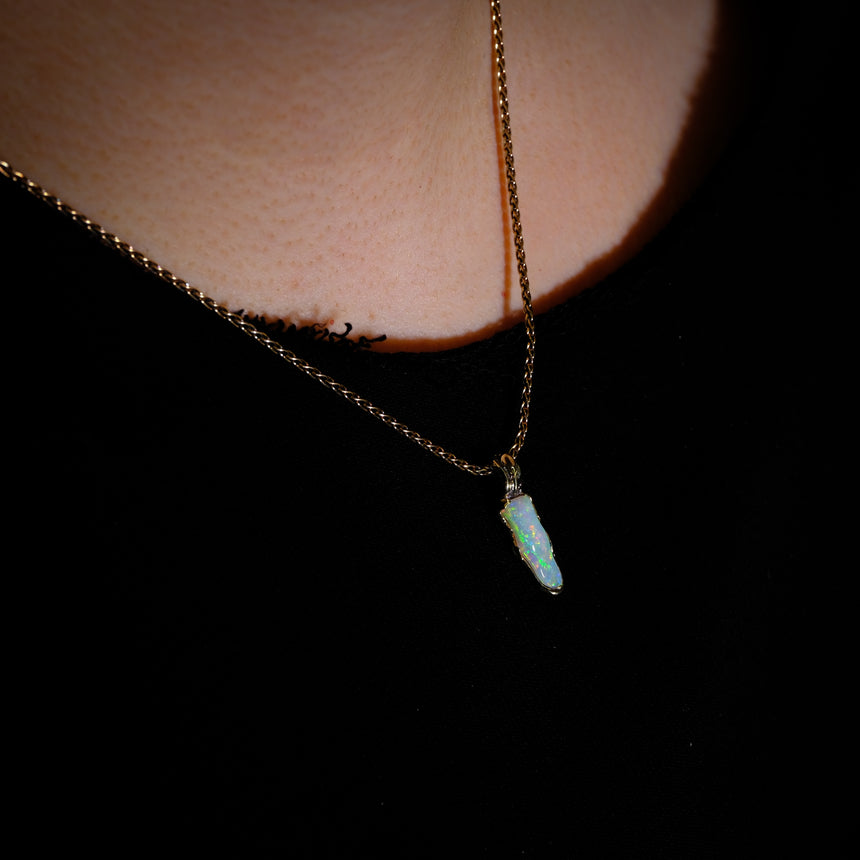 Opalised fossil and 10k gold pendant