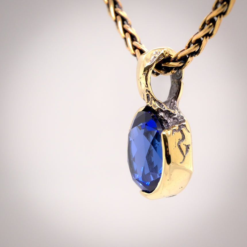 Erosion lab sapphire and 10k gold pendant