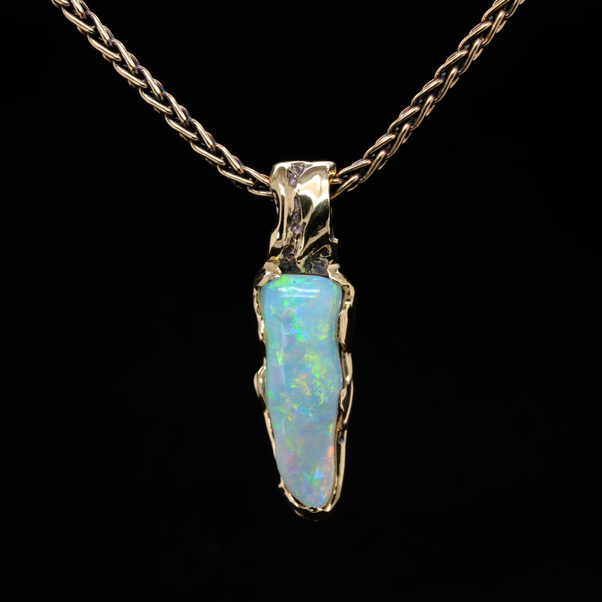 Opalised fossil and 10k gold pendant