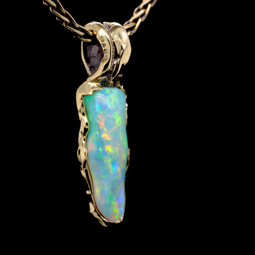 Opalised fossil and 10k gold pendant