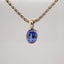 Erosion lab sapphire and 10k gold pendant